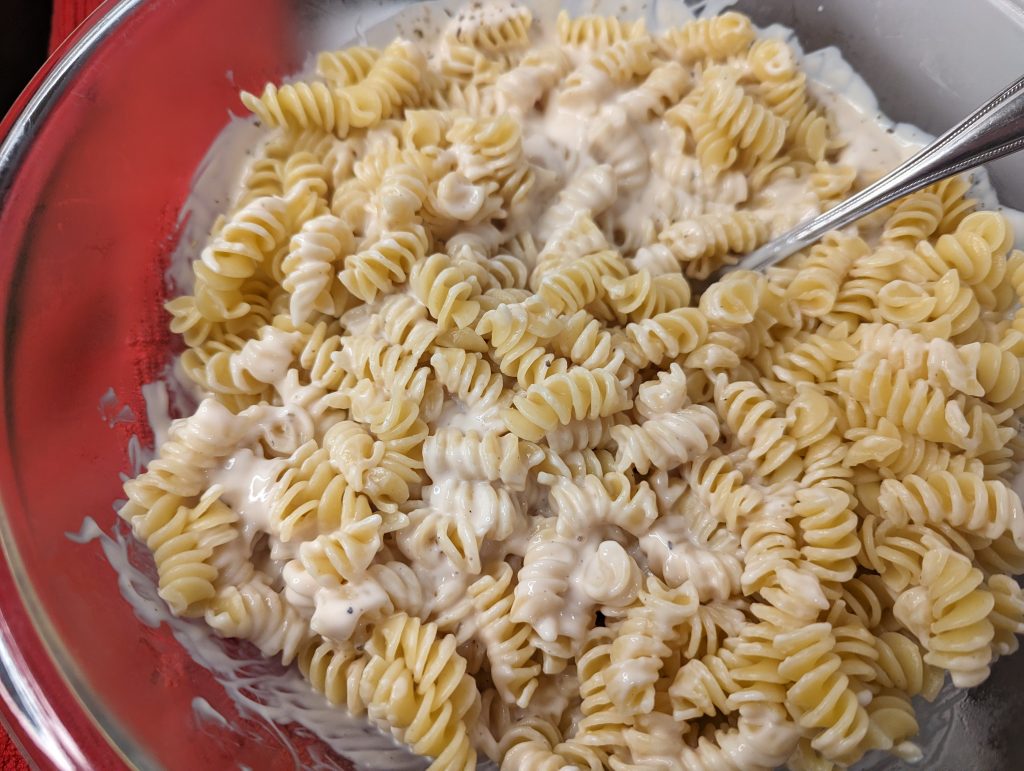 Mixing rotini with sauce