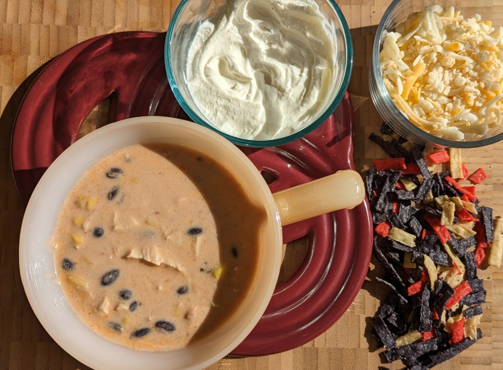 Creamy Chicken Enchilada Soup with toppings