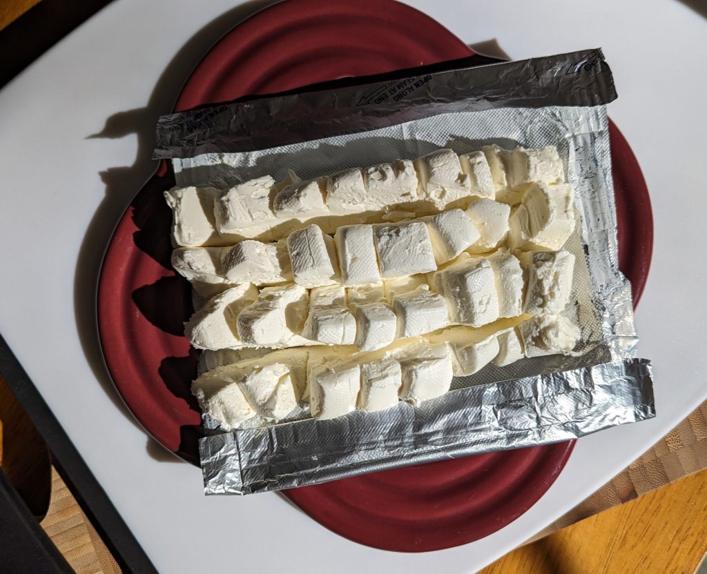 Bar of cream cheese cut into cubes