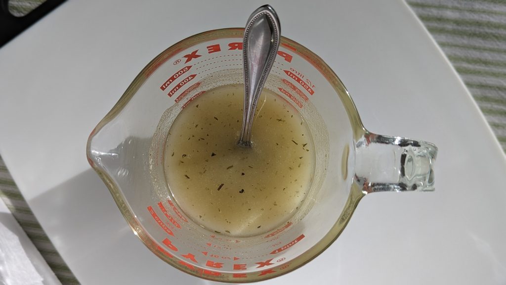 cooking oil and seasoning in pyrex measuring cup