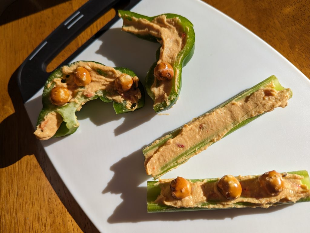 pretzel rounds being placed on celery snack