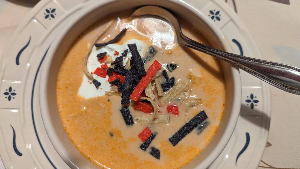 Creamy Chicken Enchilada Soup in bowl with spoon