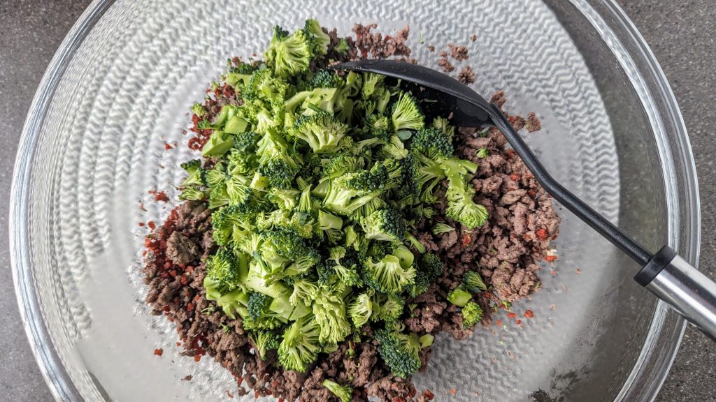 adding broccoli to the bowl