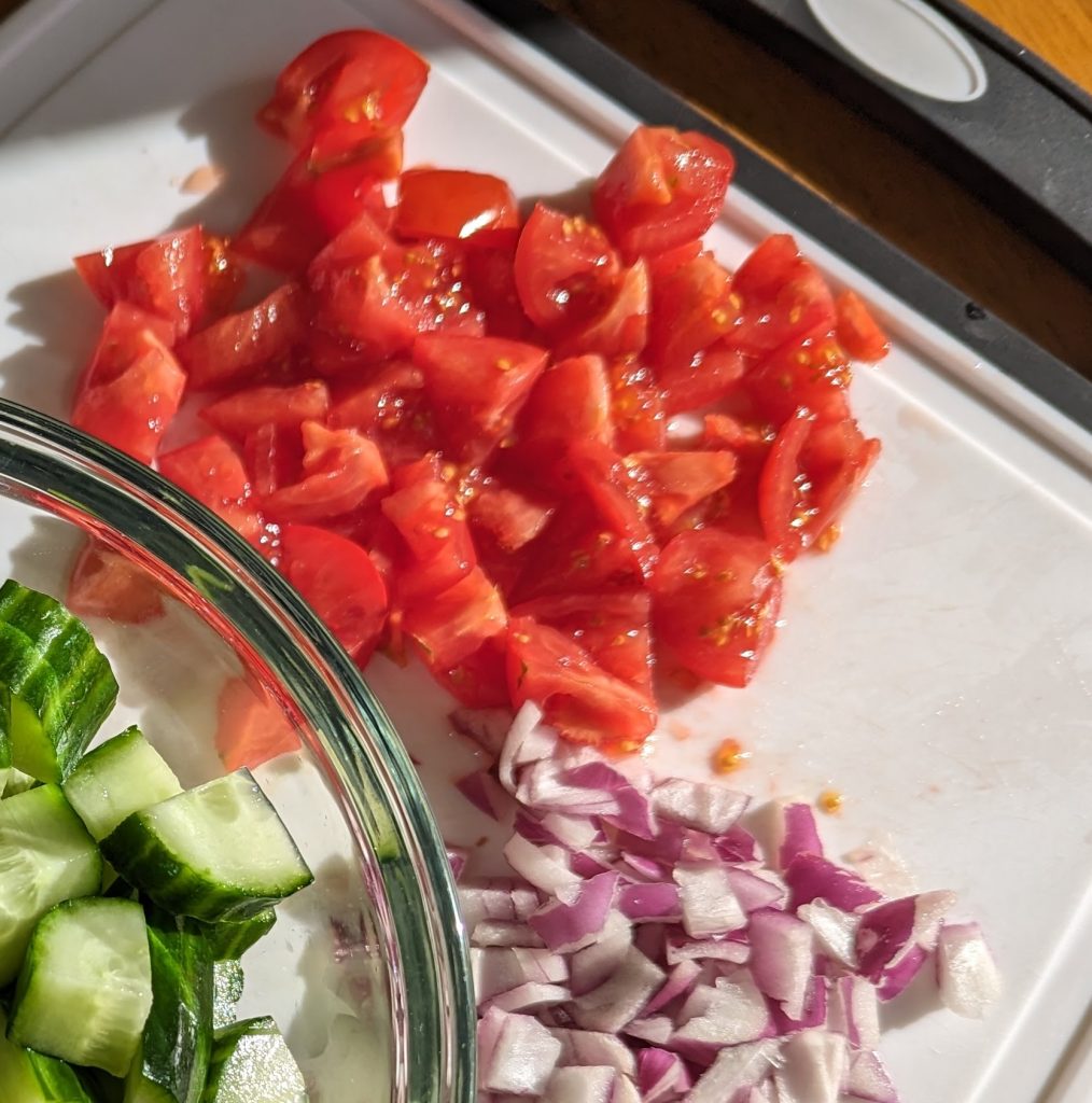 tomatoes and red onions on cutting board