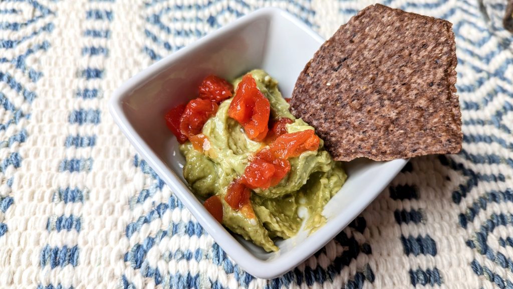 easy cheesy guacamole in serving cup