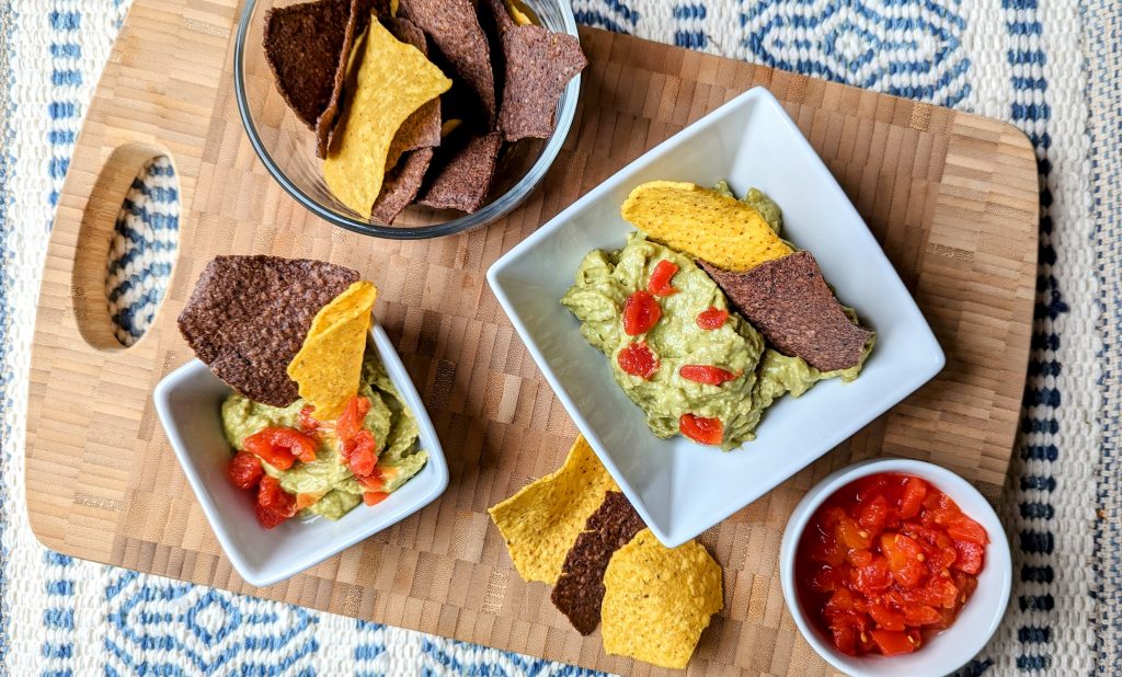 easy cheesy guacamole on serving tray