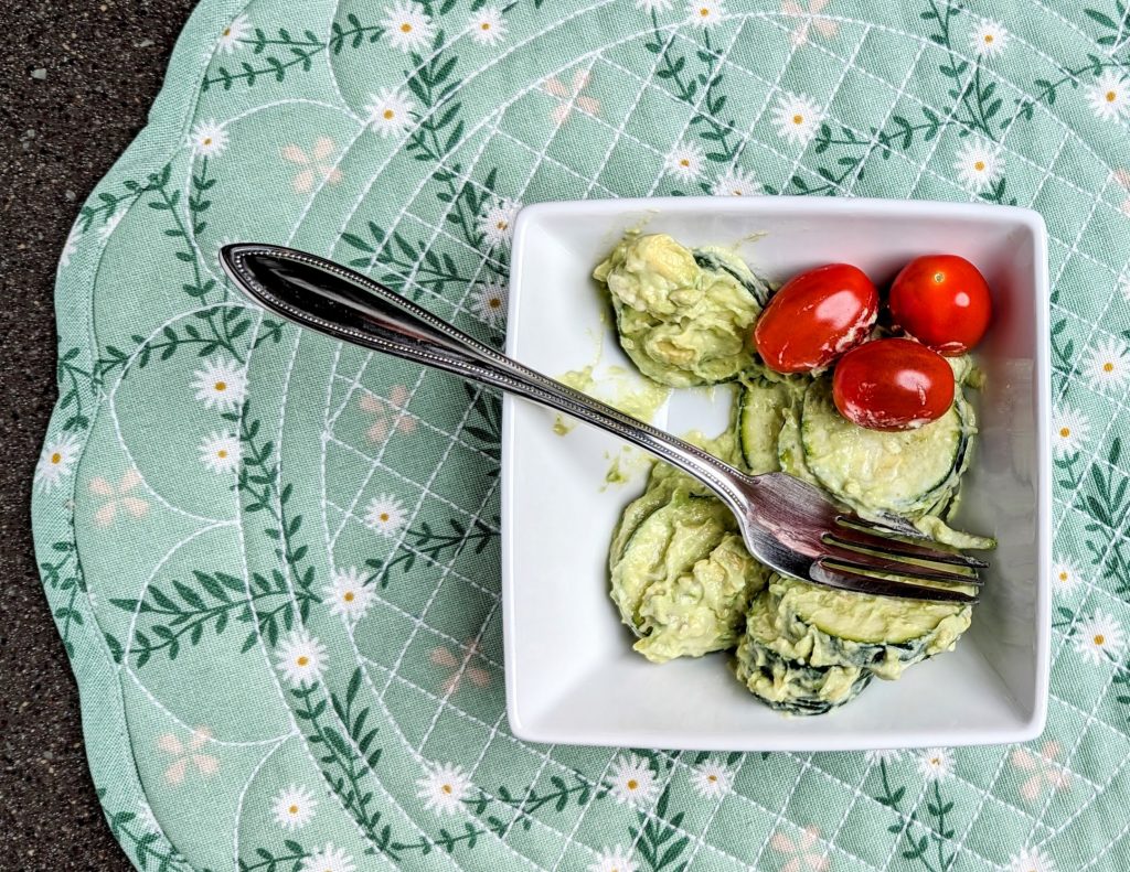 creamy avocado zucchini salad serving with fork