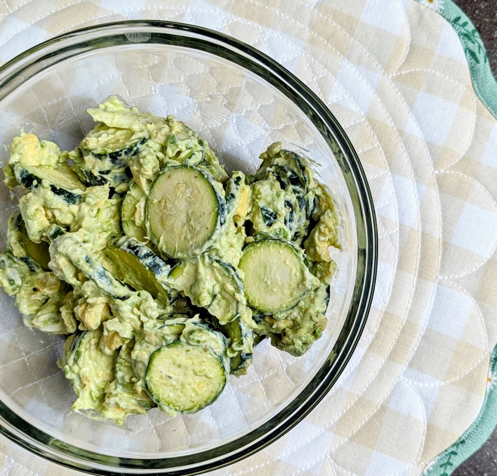 creamy avocado zucchini salad mixed in bowl