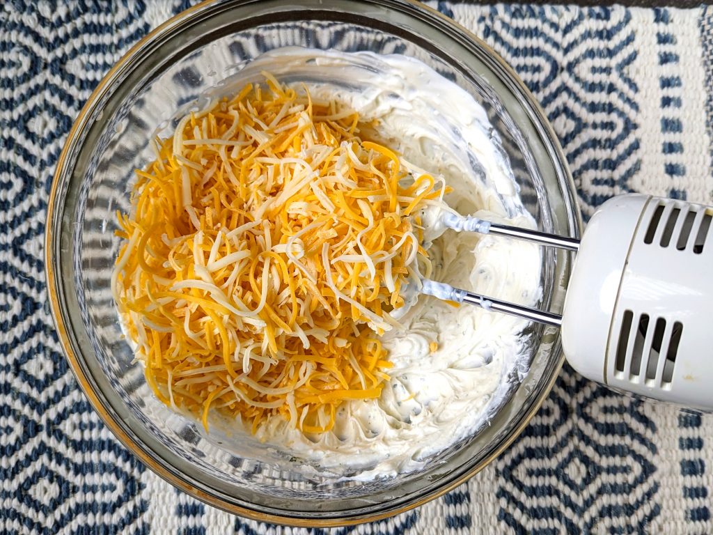 adding cheese to the bowl