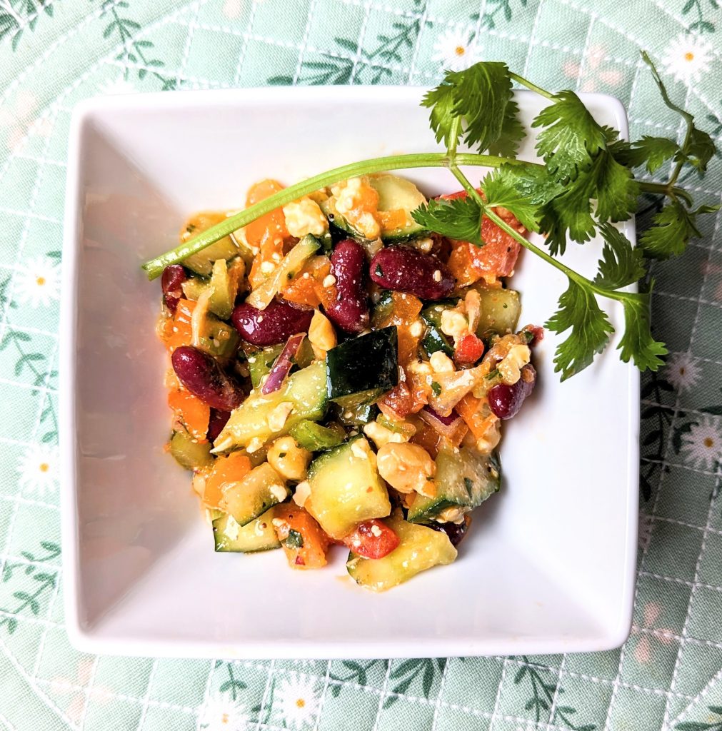 mediterannean bean salad with a sprig of cilantro