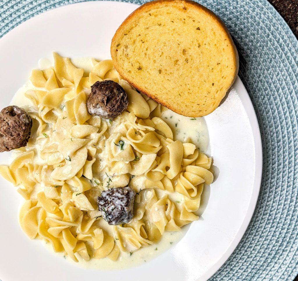 swedish meatballs with dill sauce over noodles