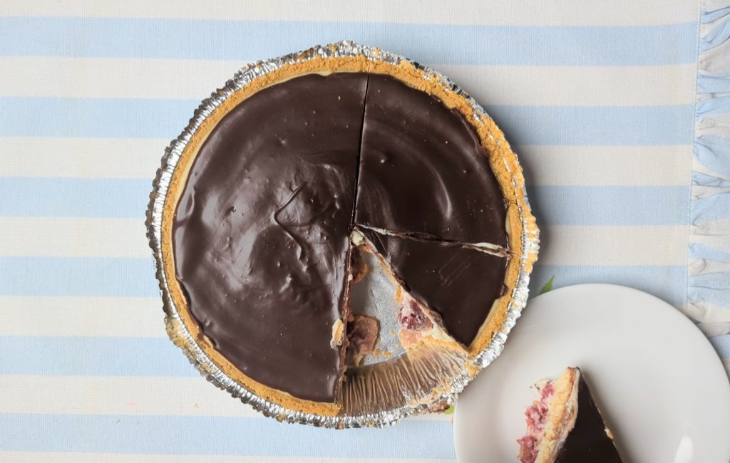 cutting chocolate raspberry cheesecake