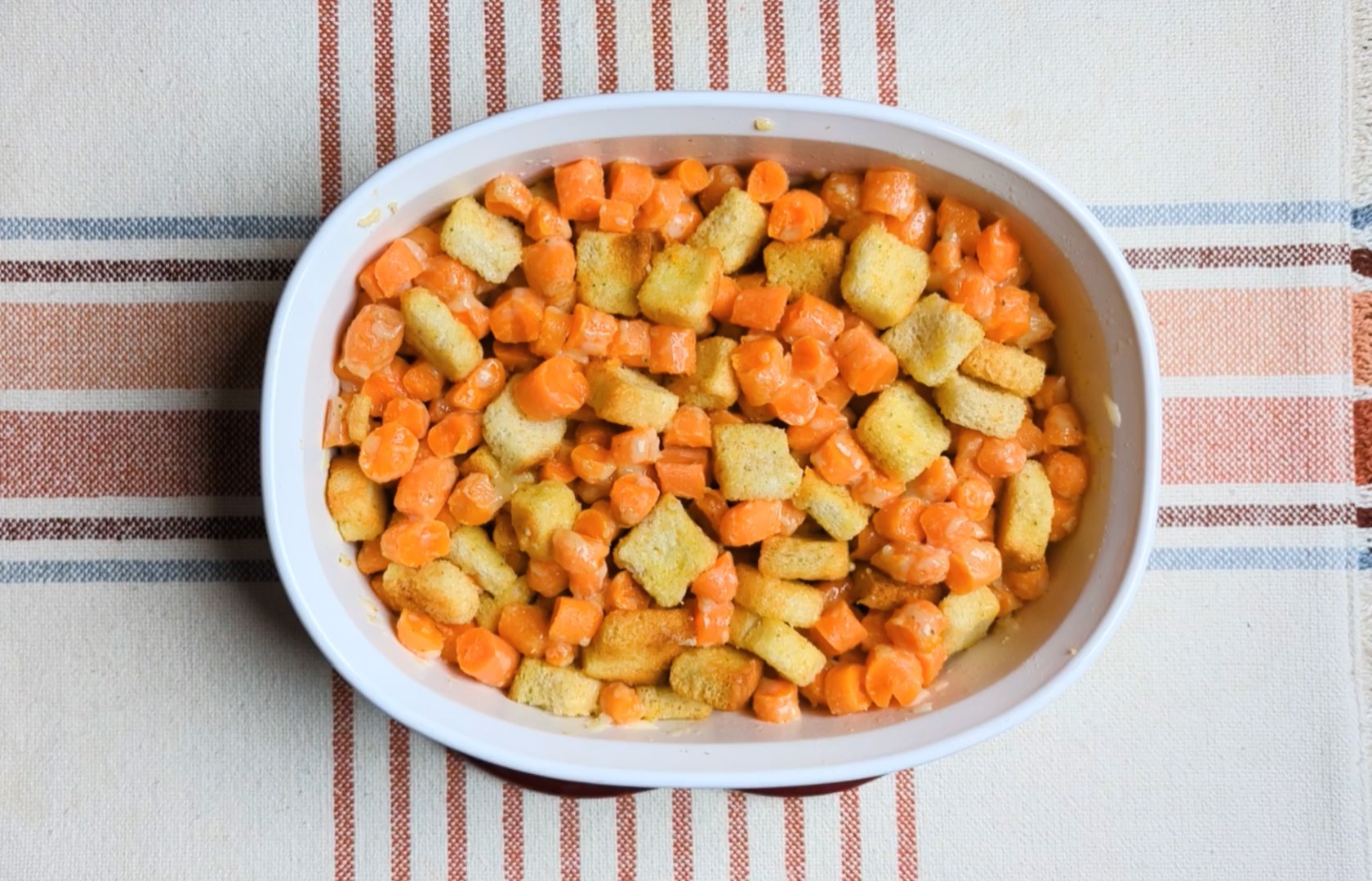 creamy cheesy carrot casserole in dish unbaked