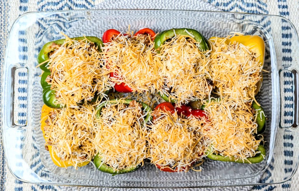 cheese sprinkled on top of Mexican stuffed peppers