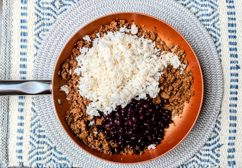 beans and rice added to the saucepan