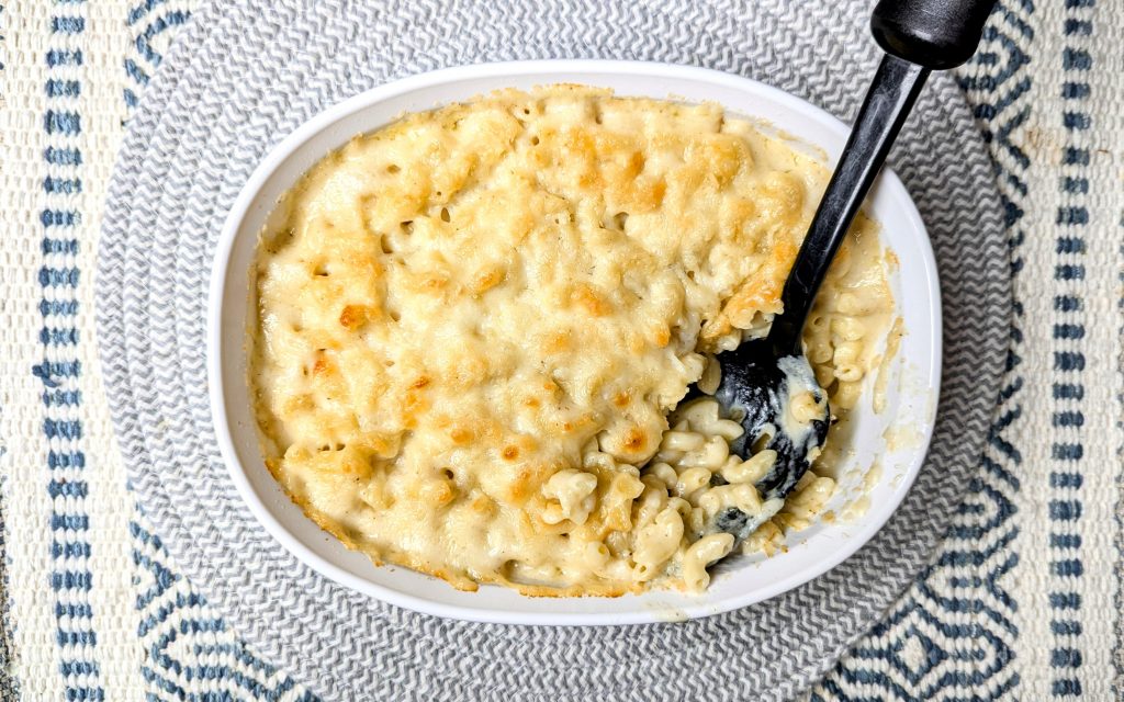 cheddar parmesan mac and cheese with serving spoon