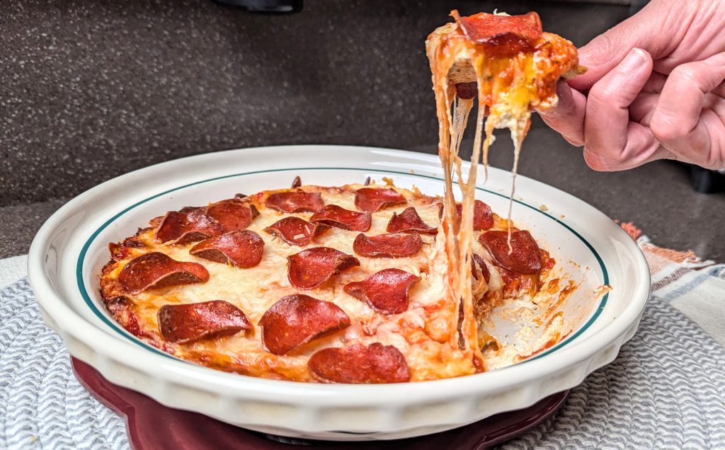 pepperoni pizza dip with a cracker