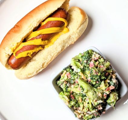 broccoli crunch salad on plate with hot dog