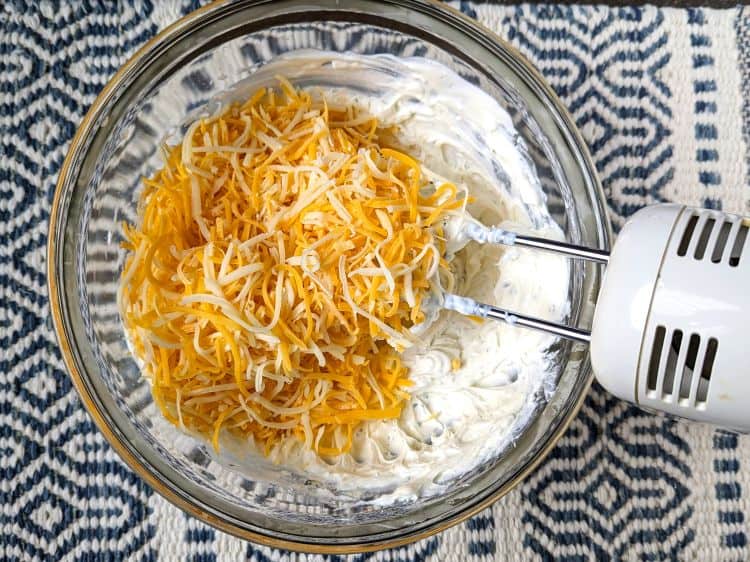 adding shredded cheese