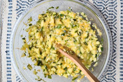 cheesy rice zucchini casserole being mixed in bowl