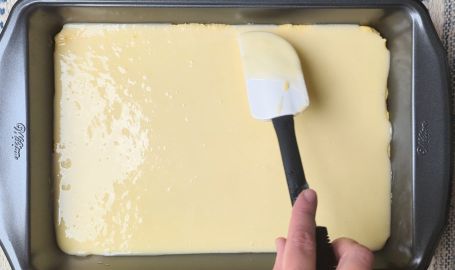 spreading glaze over butter cake