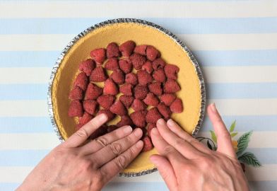 pressing raspberries into crust