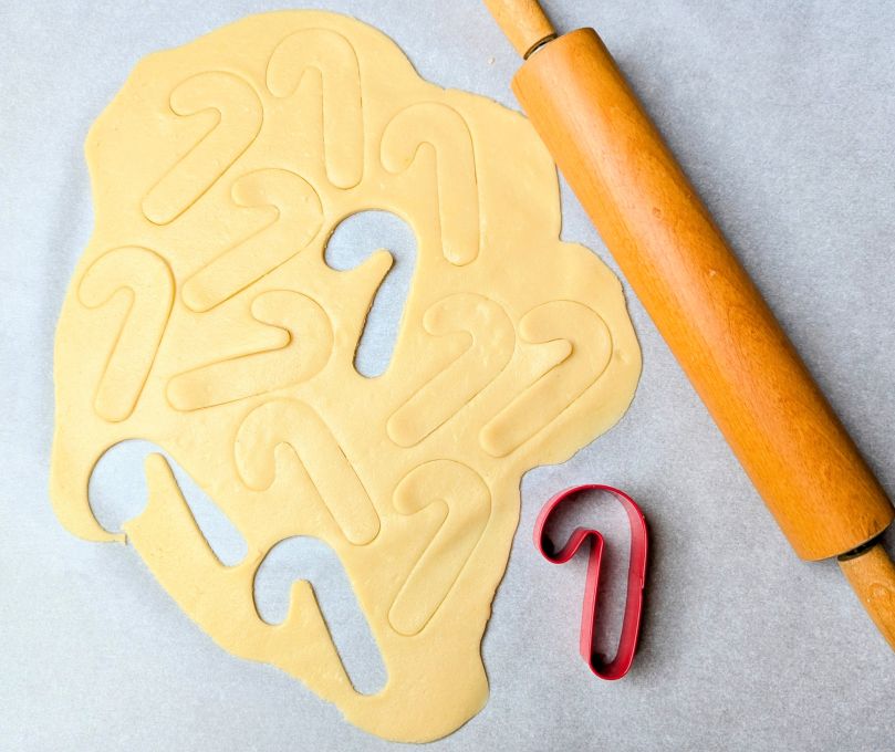 christmas butter cookie dough with rolling pin and cookie cutter