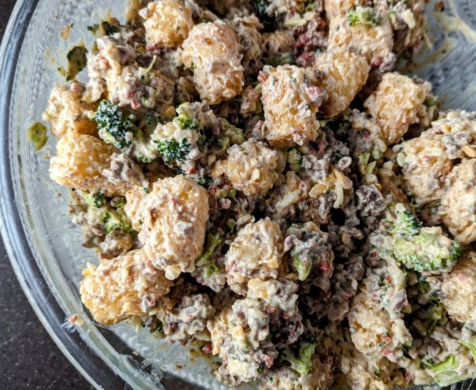 mixing cracked hamburger hash casserole in bowl