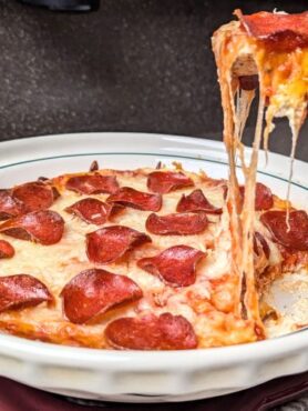 pepperoni pizza dip with a cracker