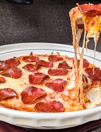 pepperoni pizza dip with a cracker