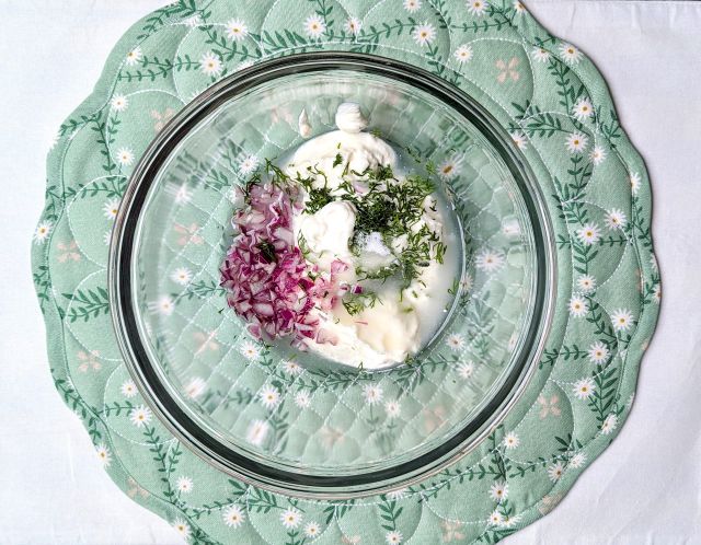 cucumber sour cream salad ingredients in bowl