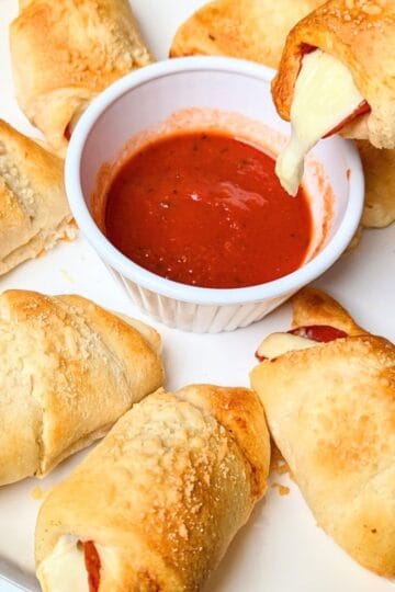 dipping pizza roll in sauce