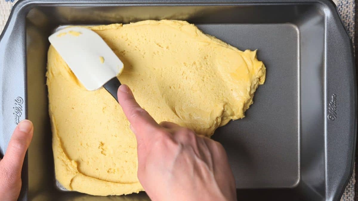 spreading cake batter into pan