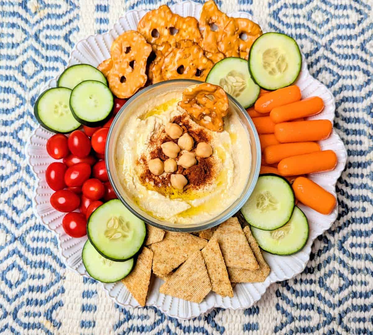 dipping pretzel in hummus