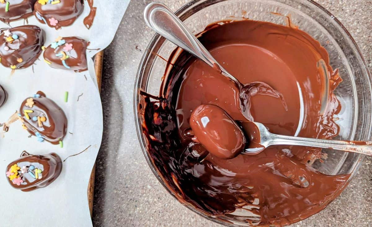 dipping eggs in melted chocolate