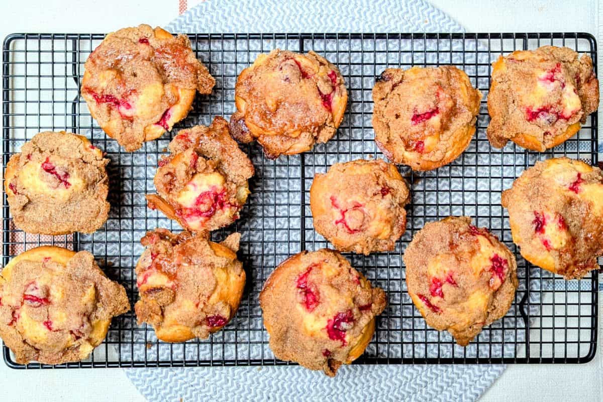cranberry muffins on wire cooling rack with cinnamon crumble topping