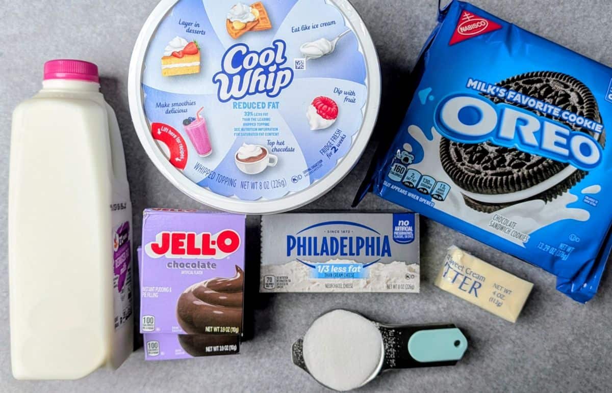 Ingredients for Easter chocolate lasagna including Oreo cookies, chocolate pudding mix, cream cheese, and Cool Whip.
