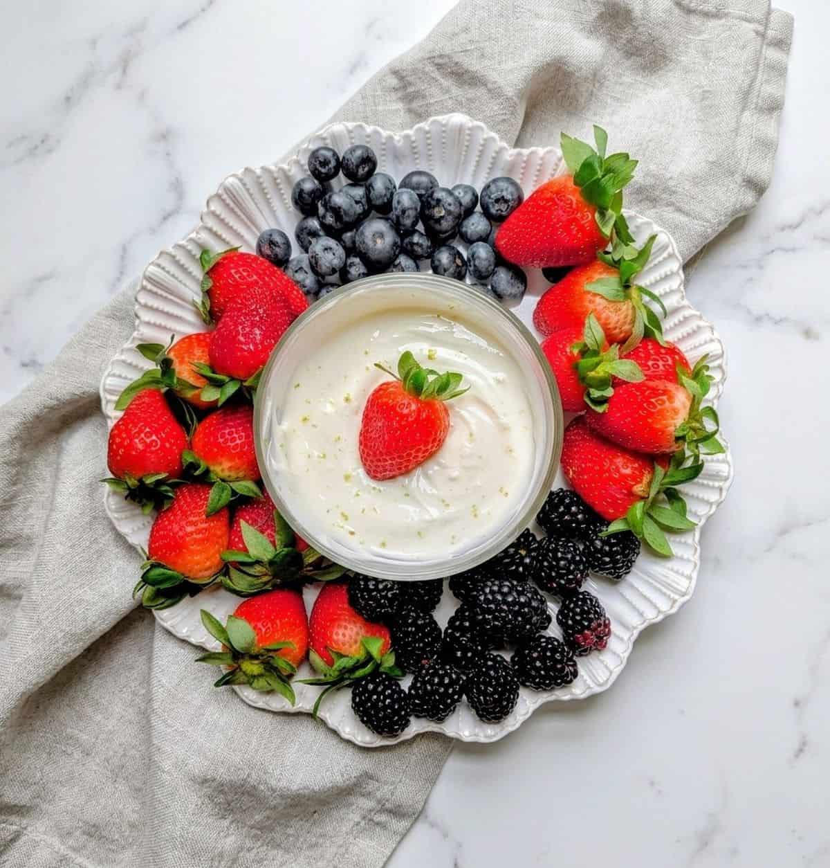 fruit dip on tray with berries