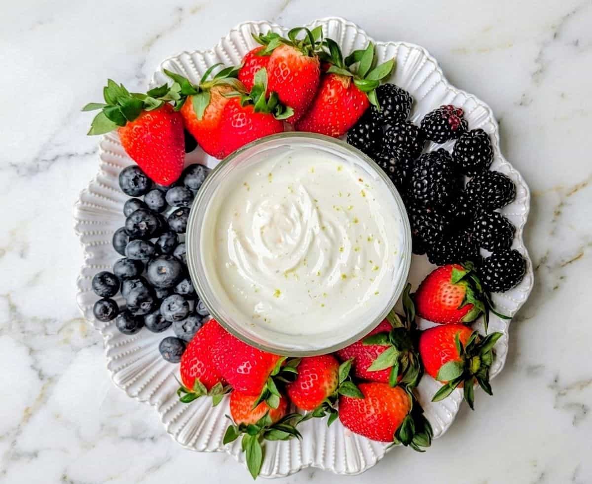 yogurt fruit dip on tray with berries