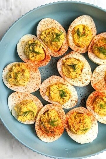 dill pickled deviled eggs in serving bowl