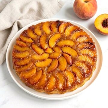 peach upside down cake on serving plate