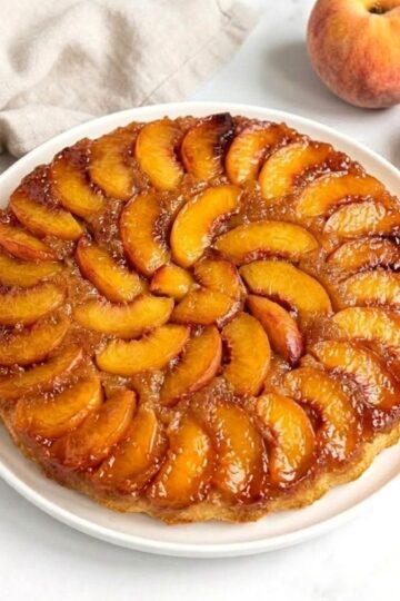 peach upside down cake on serving plate