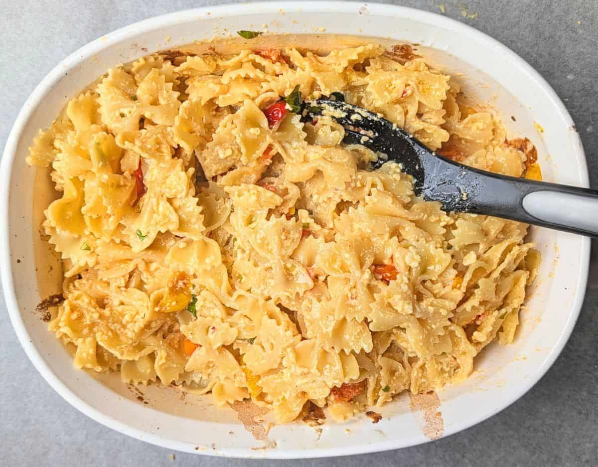 stirring in noodles and basil