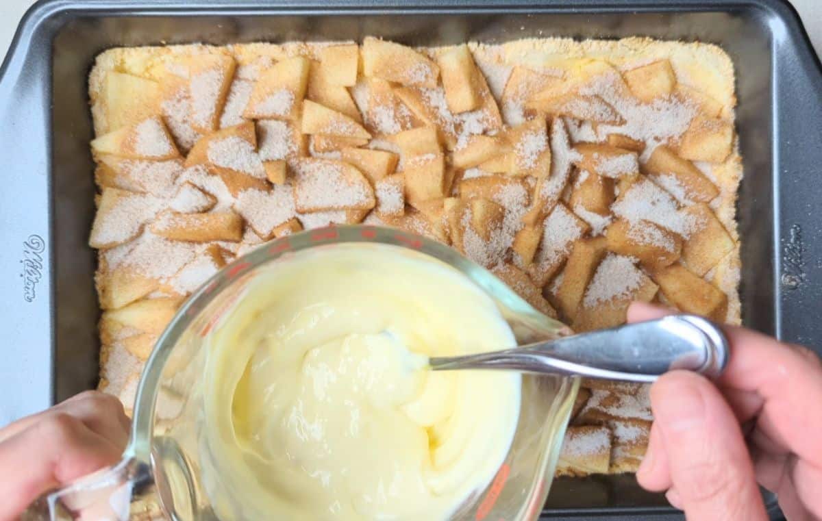 pouring homemade custard over apples