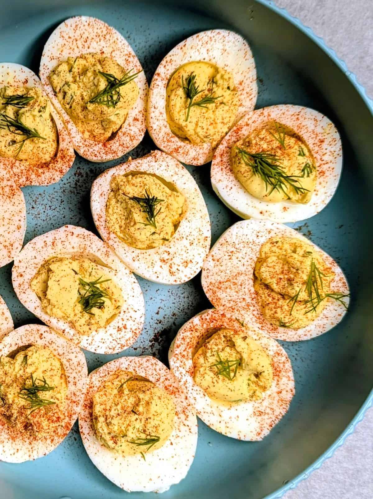 dill pickled deviled eggs in serving bowl