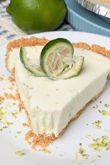 slice of key lime pie on plate with zest