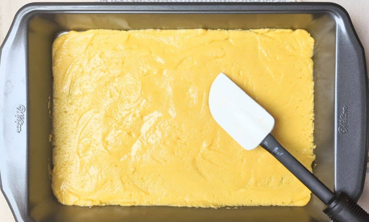 spreading thick cake batter in pan