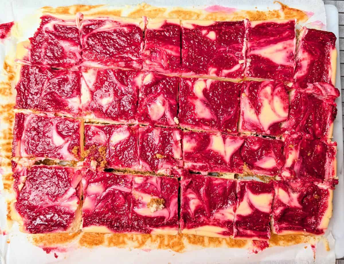 lemon raspberry cheesecake bars cut into squares