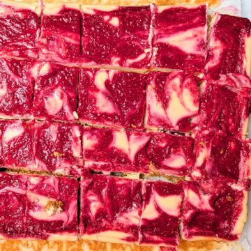 raspberry lemon cheesecake bars cut into squares