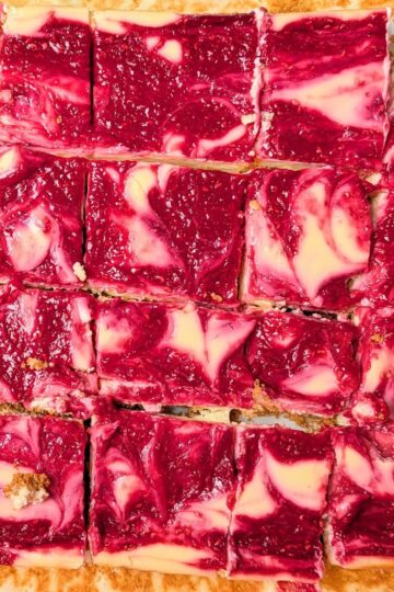 raspberry lemon cheesecake bars cut into squares